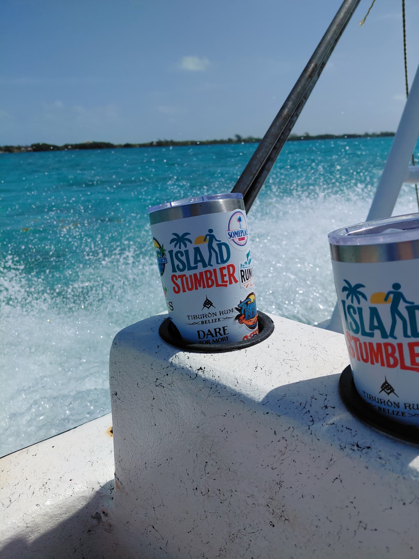 Island Stumbler tumblers on a boat in the turquoise waters of San Pedro, Belize